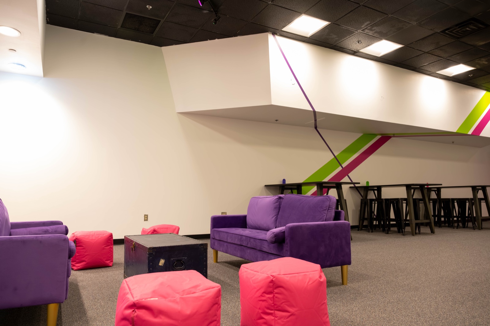 The Blast'D! lounge with purple sofas, hot-pink ottomans and bar-height tables